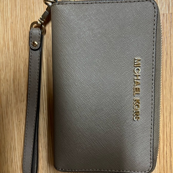 Michael Kors Accessories - Michael Kors wristlet wallet taupe color good used condition. Gold slightly worn
